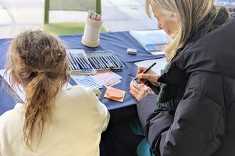 Photo of two people completing workshop based activities